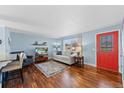 Open living space featuring hardwood floors, a decorative rug, and neutral paint at 6074 S Dudley Way, Littleton, CO 80123
