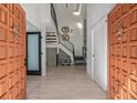 Bright foyer with modern staircase, light hardwood floors, designer lighting, and stylish decor at 5951 S Akron Way, Greenwood Village, CO 80111