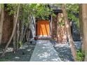 Striking stone accents frame a vibrant orange front door, creating a warm welcome to this cozy home at 5951 S Akron Way, Greenwood Village, CO 80111