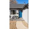 Stylish front entrance with a blue door and seating area at 2675 Kearney St, Denver, CO 80207