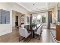 Dining room with a dark wood table, white chairs, and french doors at 2260 S Jackson St, Denver, CO 80210