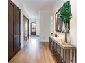 Long hallway features beautiful hardwood floors and dark wood doors at 2260 S Jackson St, Denver, CO 80210