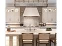 Elegant kitchen with marble countertops, designer lighting, and custom white cabinetry at 2260 S Jackson St, Denver, CO 80210