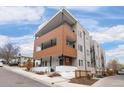 Modern condo building with a wood facade and ample windows, set against a blue sky at 1256 Xavier St, Denver, CO 80204