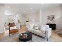 Bright living room featuring neutral decor, modern furnishings, and an open floor plan to the kitchen at 1256 Xavier St, Denver, CO 80204