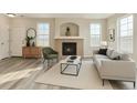 Comfortable living room showcasing a fireplace, modern furniture, neutral tones, and ample natural light at 12766 Jasmine St # F, Thornton, CO 80602