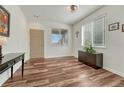 Inviting entryway with hardwood floors, neutral walls, and a large window offering plenty of natural light at 2976 Open Sky Way, Castle Rock, CO 80109