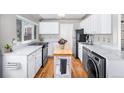 Modern kitchen with white countertops, stainless steel appliances and hardwood floors at 1421 Jasmine St, Denver, CO 80220