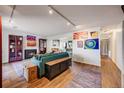 Inviting living room featuring a fireplace, hardwood floors, and colorful wall art at 2917 S Locust St, Denver, CO 80222