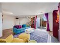 Comfortable living room with hardwood floors, bright accents, and a sliding glass door leading to an outdoor space at 2917 S Locust St, Denver, CO 80222