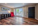 Bright living room featuring wood floors, a large window, and neutral walls at 18472 E Atlantic Dr, Aurora, CO 80013
