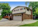 A spacious two-story home showcasing a two-car garage and brick detailing at 800 Mesa Ct, Broomfield, CO 80020