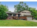 Inviting two-story home featuring a well-maintained lawn and a charming wooden deck at 800 Mesa Ct, Broomfield, CO 80020
