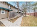 A serene backyard setting featuring a walkway, secure fence and a well-maintained lawn for leisure at 5928 S Willow Way, Greenwood Village, CO 80111