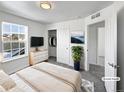 Virtually staged bedroom with large window and walk-in closet at 9437 E 108Th Dr, Commerce City, CO 80640