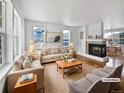 Spacious living room with hardwood floors and a fireplace, virtually staged at 9437 E 108Th Dr, Commerce City, CO 80640