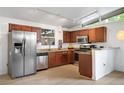 Updated kitchen features stainless steel appliances, granite countertops, track lighting and wood cabinets at 491 Campo St, Denver, CO 80221