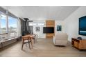 Living room features natural lighting, wood floors, wood burning fireplace and modern furniture at 491 Campo St, Denver, CO 80221