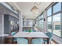 Open floor plan with modern kitchen, dining area and living room, enhanced by a dazzling chandelier at 3100 Huron St # 2D, Denver, CO 80202