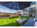 Chic rooftop terrace with artificial grass, modern outdoor furniture, and ample space for entertaining at 3100 Huron St # 2D, Denver, CO 80202