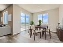 Bright dining room with wood table, slider to deck, and neutral walls and trim at 14390 Heritage Dr, Mead, CO 80504