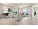 Bright living room with contemporary furniture, light wood floors, and large windows offering great views at 14390 Heritage Dr, Mead, CO 80504