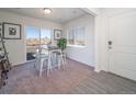 Bright dining area with table and chairs,sliding glass door and hardwood floors at 45004 Sunflower Ln, Bennett, CO 80102