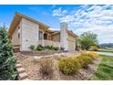 Charming home featuring stone accents, manicured landscaping and a welcoming entrance, offering great curb appeal at 17670 W 94Th Dr, Arvada, CO 80007