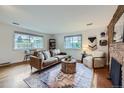Bright living room with hardwood floors, neutral furniture, and large windows at 13211 W 32Nd Ave, Golden, CO 80401