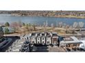 Stunning aerial view of modern townhomes overlooking a picturesque lake and tennis court at 4072 W 17Th Ave, Denver, CO 80204