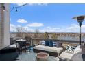Relaxing rooftop deck with plush seating, fire pit, and panoramic views of the lake and blue skies at 4072 W 17Th Ave, Denver, CO 80204