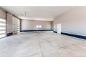 Spacious three-car garage with epoxy flooring and plenty of room for vehicles and storage at 56520 E 74Th Ave, Strasburg, CO 80136