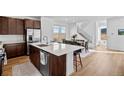 Bright kitchen features a large island, stainless steel appliances and opens to the dining area with scenic views at 15606 W Girard Ave, Morrison, CO 80465