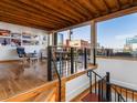Bright living room featuring hardwood floors, an industrial ceiling, and access to a deck at 1792 Wynkoop St # 508, Denver, CO 80202