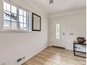 Welcoming entryway features hardwood floors, a white door with decorative glass and ample light at 3610 Olive St, Denver, CO 80207