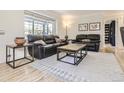 Bright living room with hardwood floors, a comfortable seating area and a large window at 3610 Olive St, Denver, CO 80207