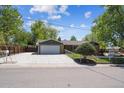 Ranch-style home featuring a spacious driveway and attached two-car garage at 1522 Utah St, Golden, CO 80401