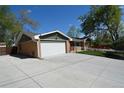 Spacious garage with a wide driveway and partial view of the home at 1522 Utah St, Golden, CO 80401