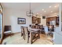 Dining area open to kitchen featuring hardwood floors and modern lighting at 31058 Big Bear Dr, Evergreen, CO 80439
