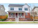 Charming two-story home featuring a welcoming front porch and classic red brick accents at 5404 W 95Th Pl, Westminster, CO 80020