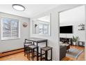 Bright dining area with seating for three and view into living space through pass-through window at 148 S Emerson St # 206, Denver, CO 80209