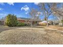 View of the home showing the front yard and a mature tree at 435 Cody Dr, Lakewood, CO 80226