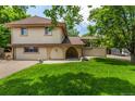 Charming two-story home with manicured lawn and unique brick portico at 3525 S Brentwood St, Lakewood, CO 80235
