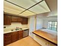 Bright kitchen with wood cabinets, stainless steel appliances, and open access to the living room at 13992 E Marina Dr # 303, Aurora, CO 80014