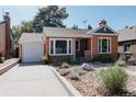 Charming brick home with a well-manicured front yard and a detached one-car garage at 3055 Clermont St, Denver, CO 80207