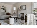 Cozy living room with a decorative fireplace, comfortable seating, and a soft, inviting ambiance at 3055 Clermont St, Denver, CO 80207