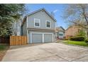 Inviting two-story home with attached two-car garage, spacious driveway and manicured yard at 11908 W Aqueduct Dr, Littleton, CO 80127