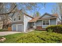 Two-story home featuring an attached two-car garage, well maintained lawn and manicured bushes at 11908 W Aqueduct Dr, Littleton, CO 80127
