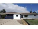 Single-story home with garage, modern front door and rock landscaping at 951 E 10Th Ave, Broomfield, CO 80020