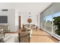 Virtually staged dining area with hardwood floors and access to balcony at 1250 N Humboldt St # 1002, Denver, CO 80218